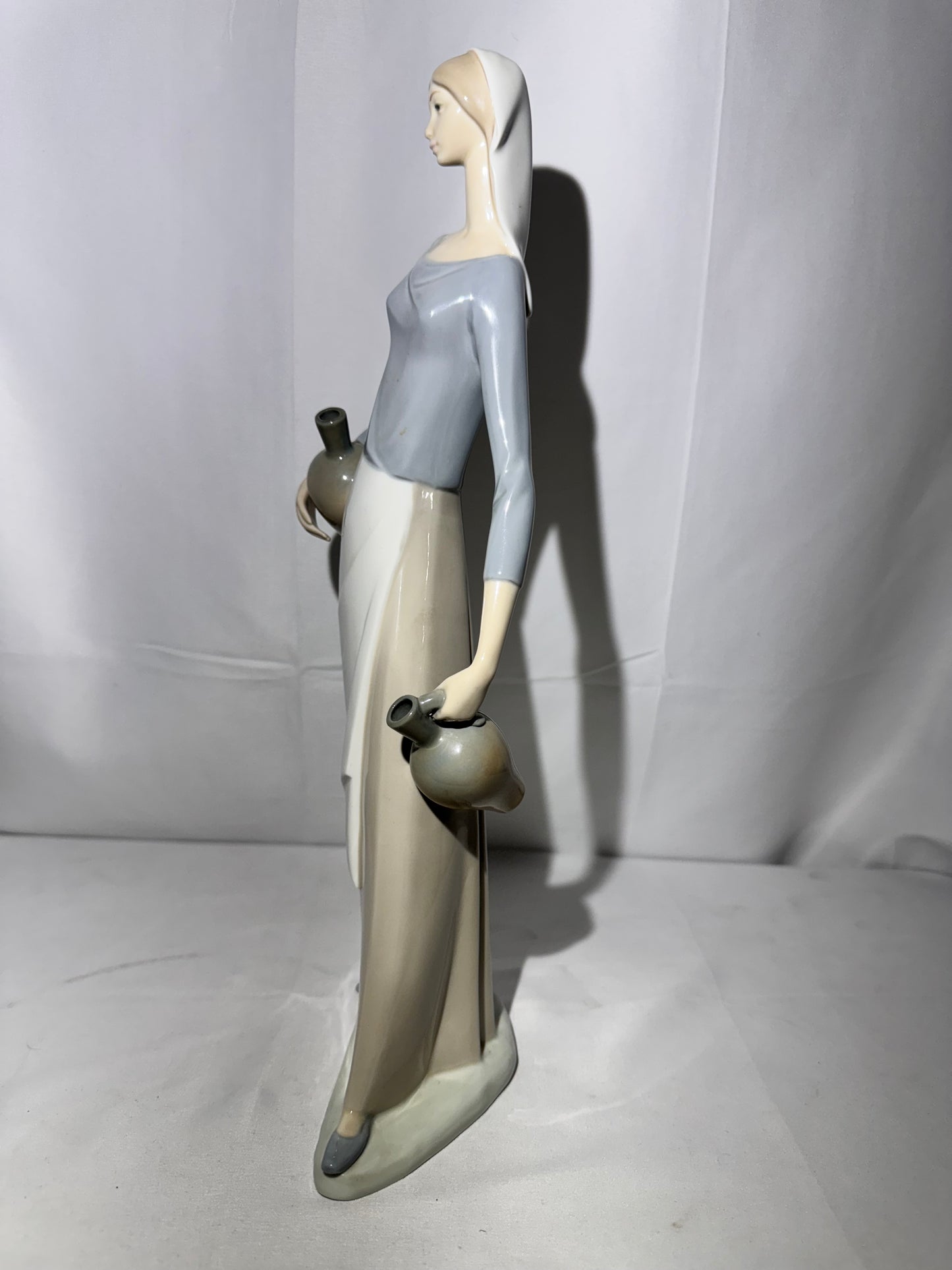 Lladro NAO Porcelain Figurine – “The Jug Carrier” (Water Carrier with Jugs) – Designed by Fulgencio Garcia, 1974