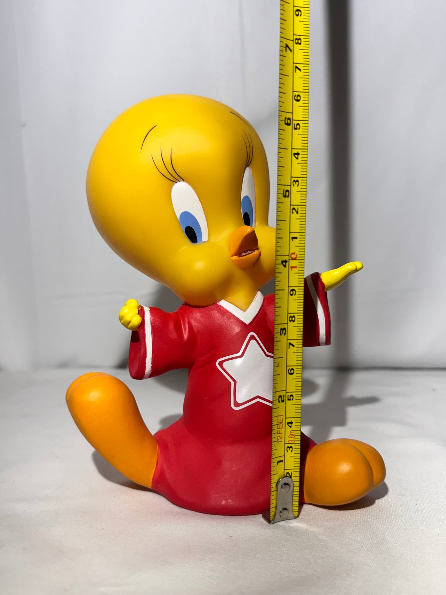Vintage 1998 Tweety vinyl piggy bank made by Warner Bros.Tweety is wearing a jersey with a star on the front.