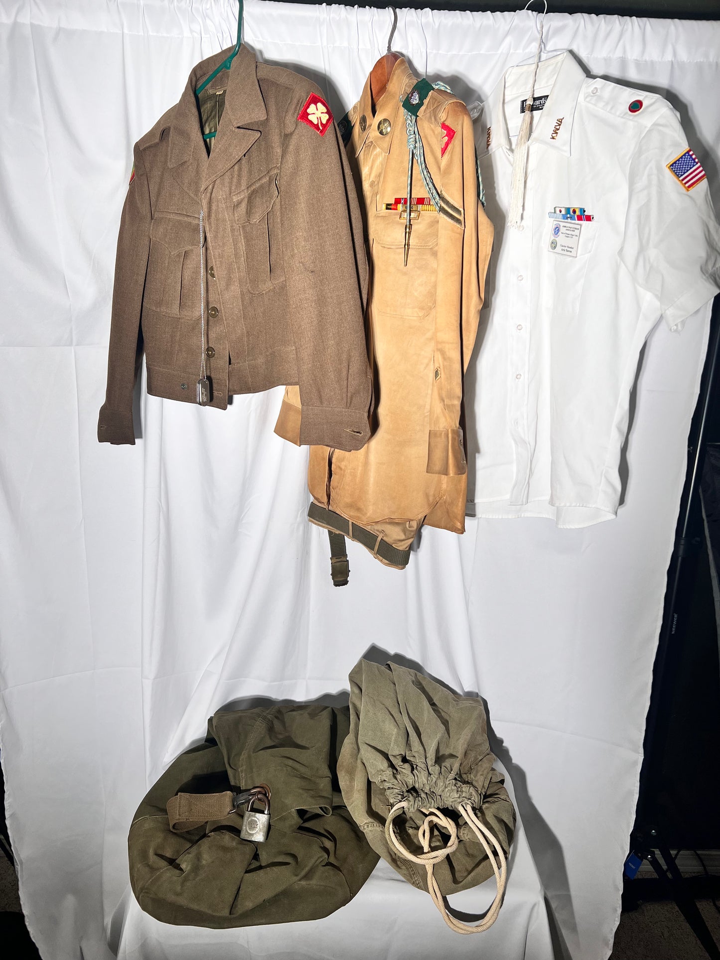 World War II lot - military uniform- dog tags- 2 duffel bags- decorated and patches on uniform