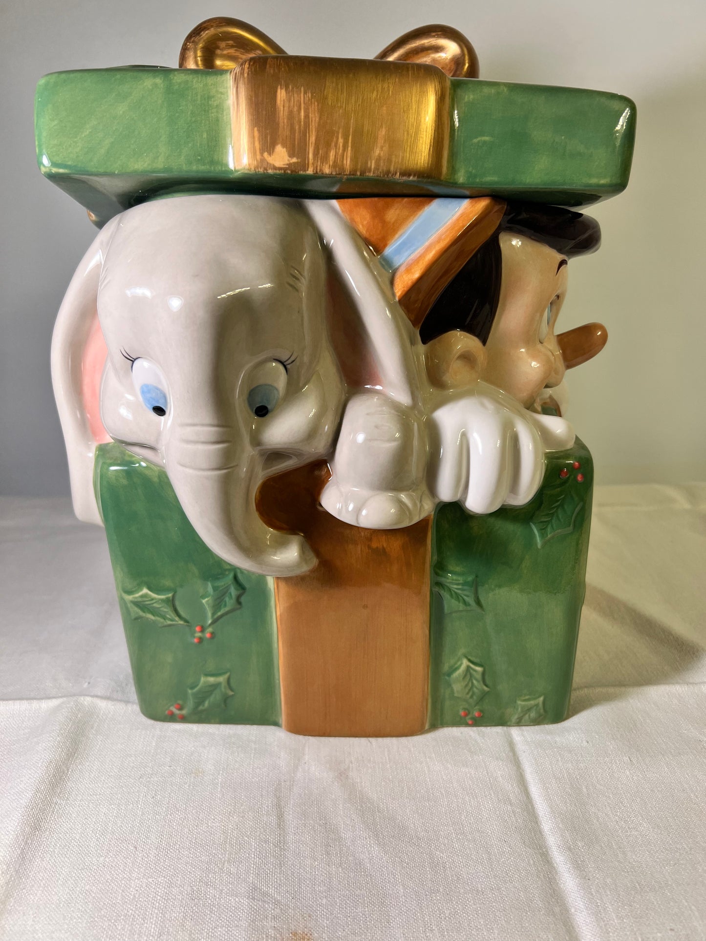 Dumbo, dopey, Pinocchio, and Mickey Mouse peeking out of a present -cookie jar-Disney-#25037