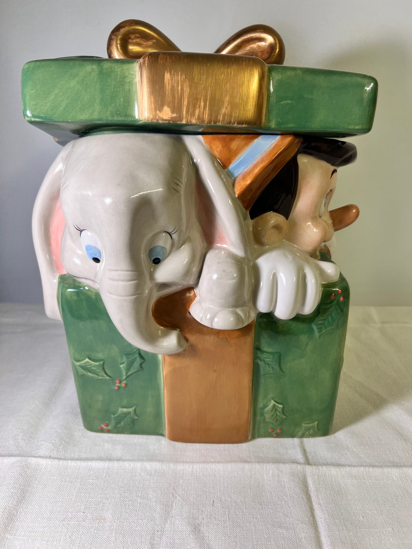 Dumbo, dopey, Pinocchio, and Mickey Mouse peeking out of a present -cookie jar-Disney-#25037
