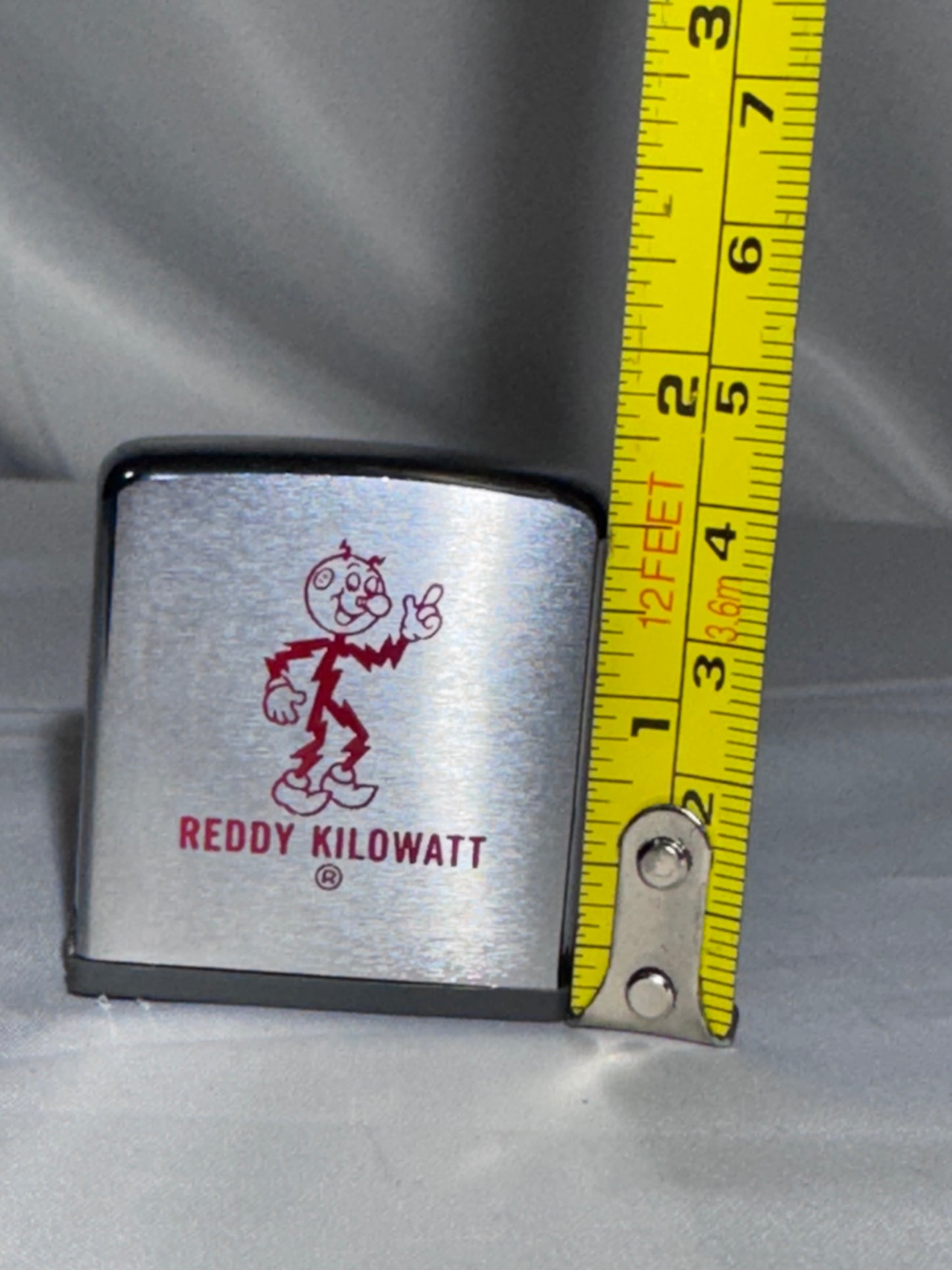 Vintage 1960s Zippo Reddy Kilowatt Advertising Tape Measure – Brushed Chrome