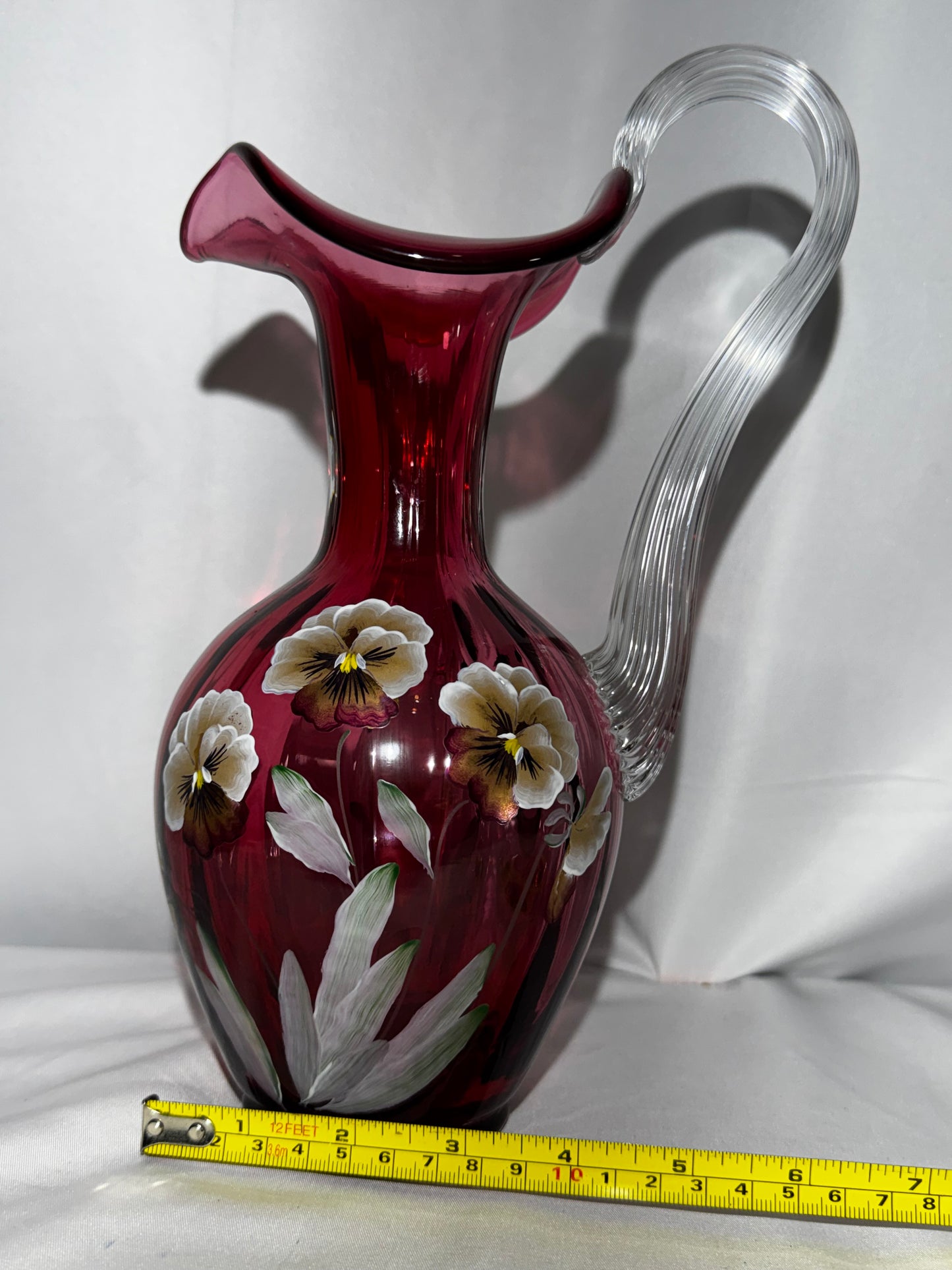 Fenton Art Glass Cranberry “Pansies” Hand-Painted Pitcher – 10.5” Fluted Ribbon Handle