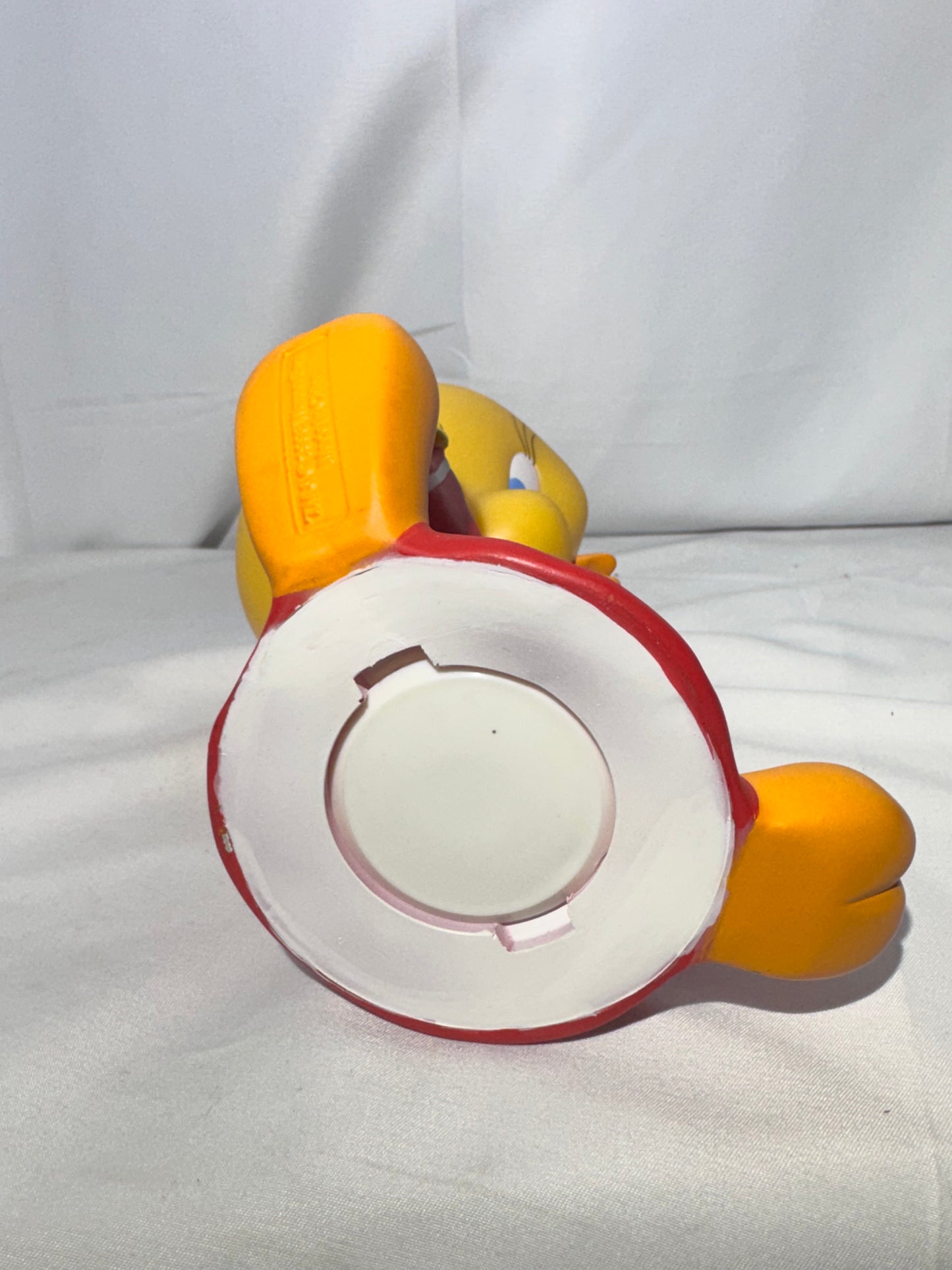 Vintage 1998 Tweety vinyl piggy bank made by Warner Bros.Tweety is wearing a jersey with a star on the front.