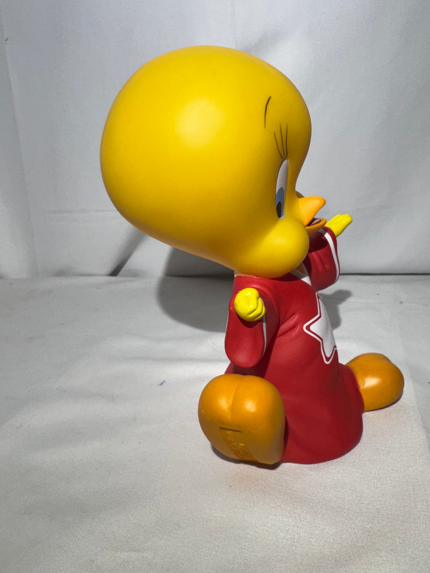 Vintage 1998 Tweety vinyl piggy bank made by Warner Bros.Tweety is wearing a jersey with a star on the front.