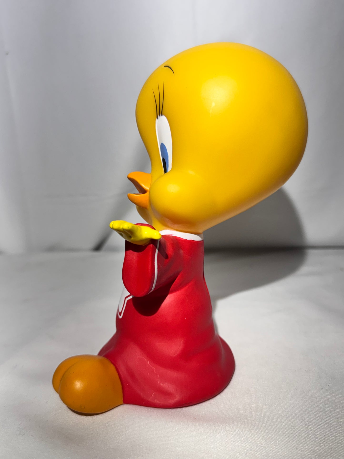 Vintage 1998 Tweety vinyl piggy bank made by Warner Bros.Tweety is wearing a jersey with a star on the front.