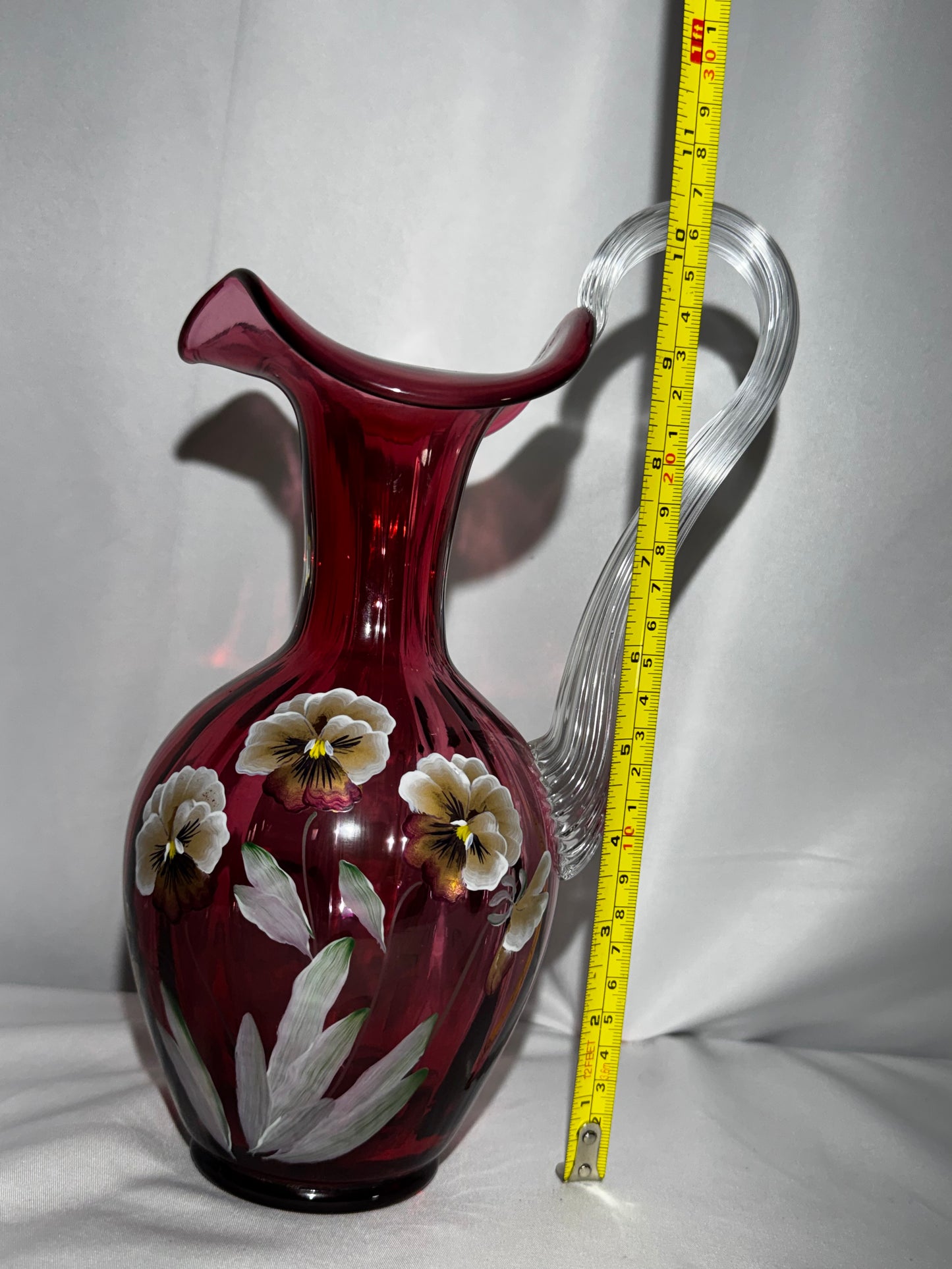 Fenton Art Glass Cranberry “Pansies” Hand-Painted Pitcher – 10.5” Fluted Ribbon Handle