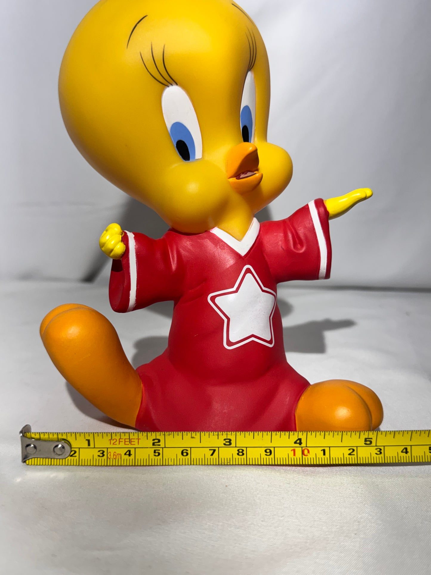 Vintage 1998 Tweety vinyl piggy bank made by Warner Bros.Tweety is wearing a jersey with a star on the front.