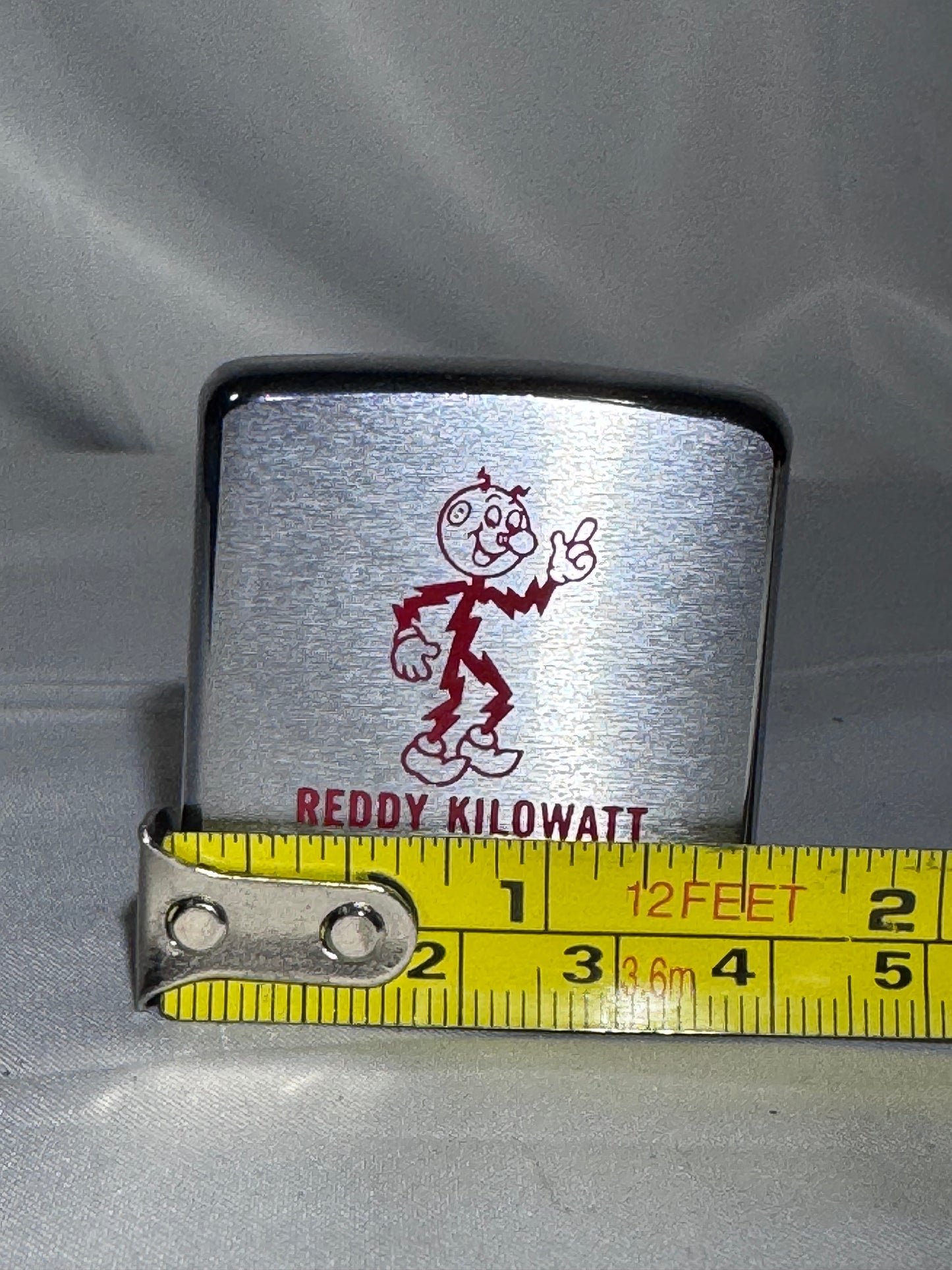 Vintage 1960s Zippo Reddy Kilowatt Advertising Tape Measure – Brushed Chrome
