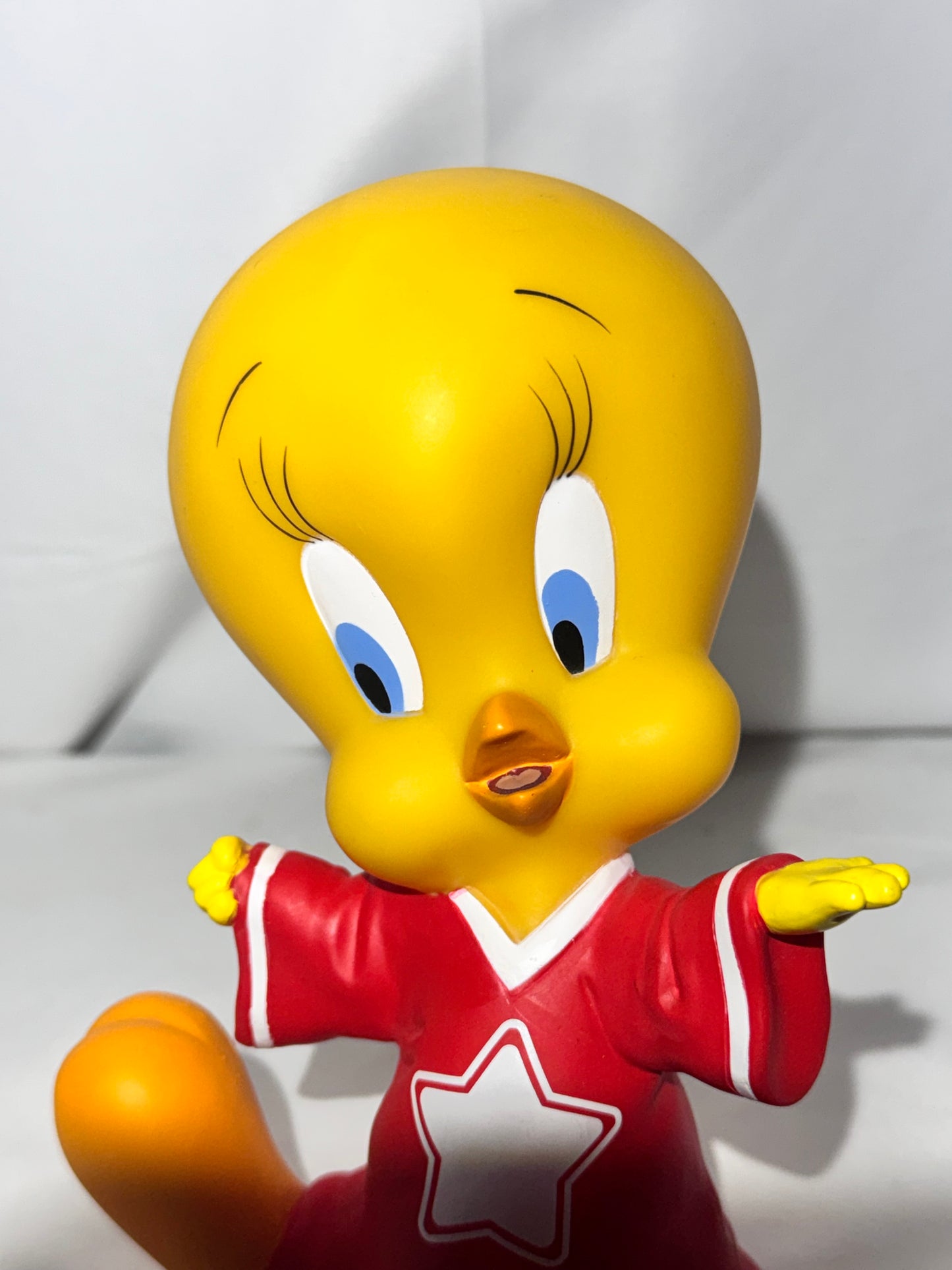 Vintage 1998 Tweety vinyl piggy bank made by Warner Bros.Tweety is wearing a jersey with a star on the front.