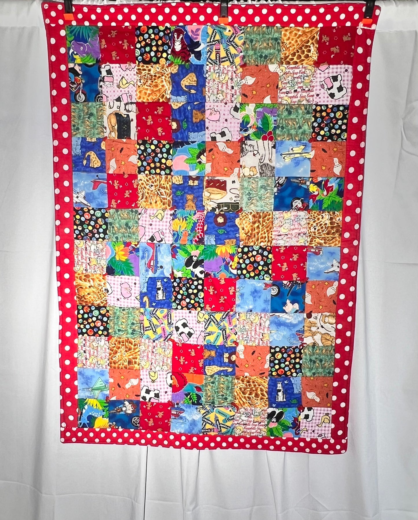Quilt- fun print squares- 33” x 46” - polkadot trim- kid or baby blanket