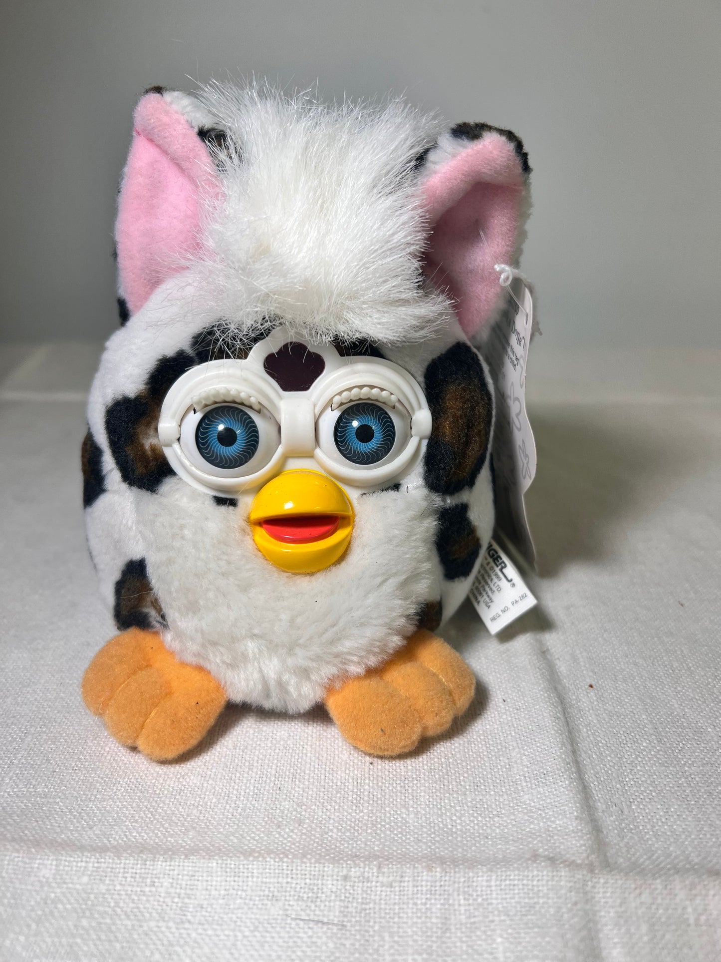 Furby Buddies-Joke Done- 1999- Tiger Electronics- white with brown and black spots- Blue Eyes