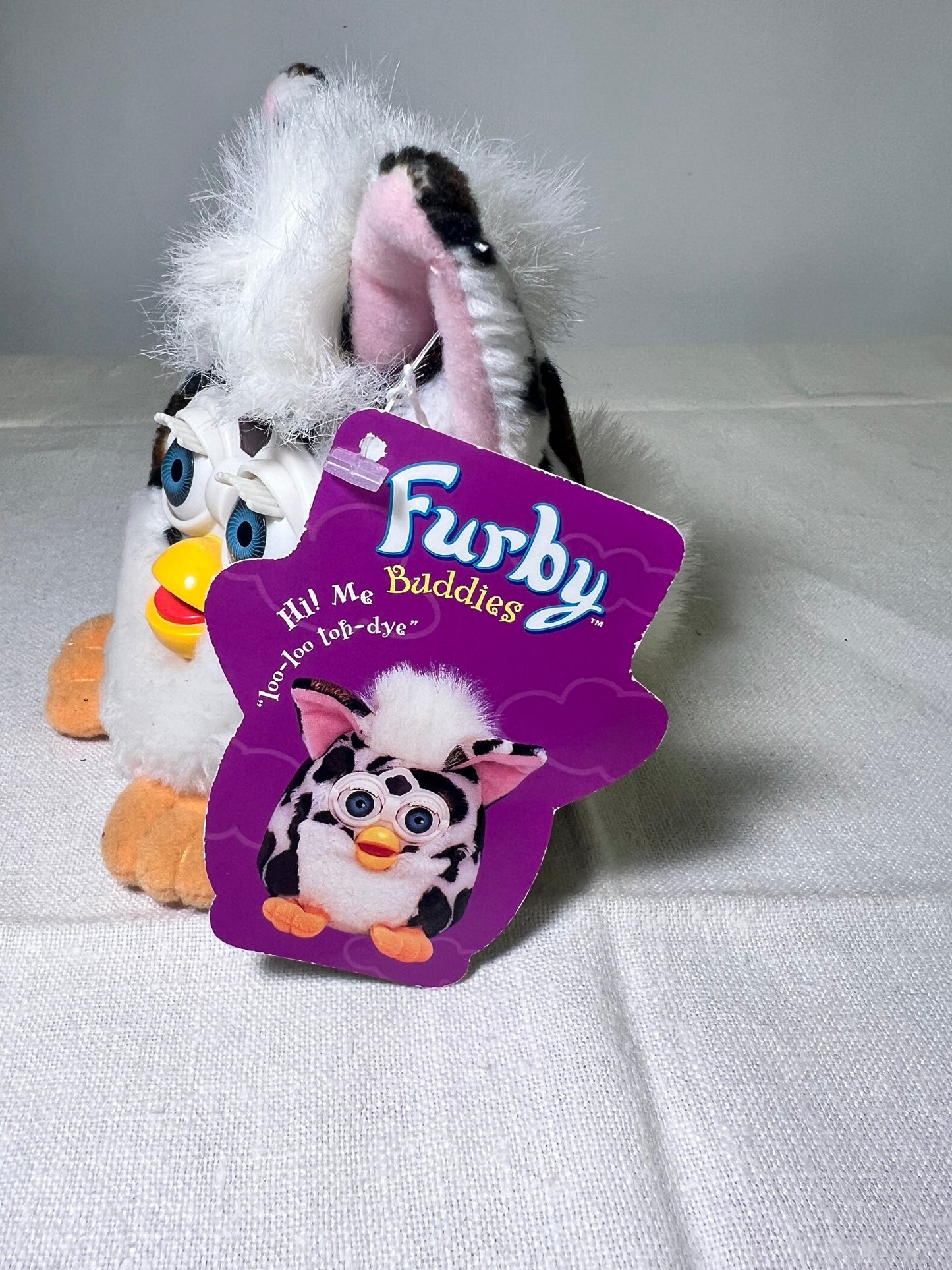 Furby Buddies-Joke Done- 1999- Tiger Electronics- white with brown and black spots- Blue Eyes