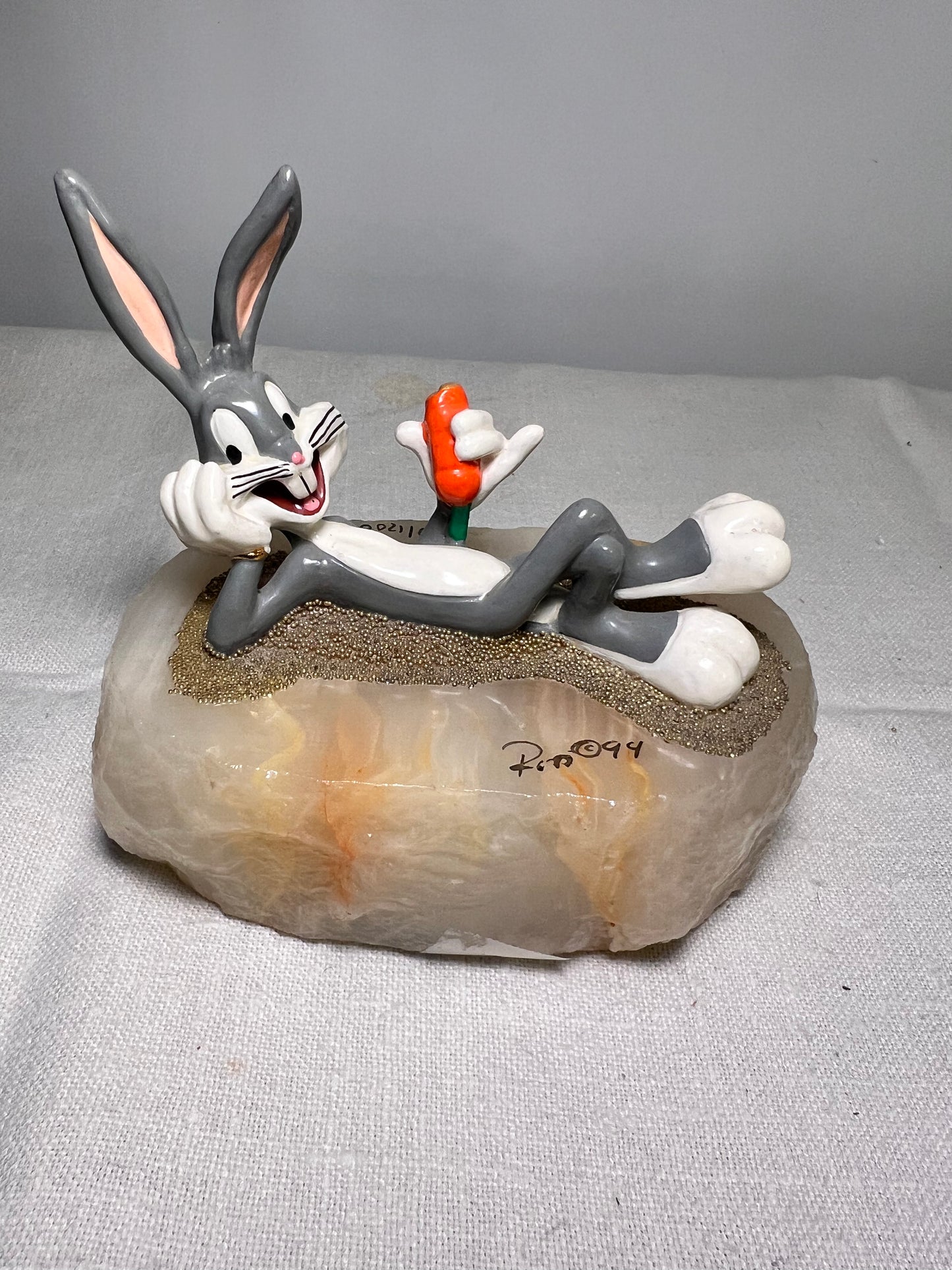 Ron Lee - Bugs Bunny- 4” statue - laying with a carrot- signed and numbered 517\1200- 1993-stone base-Looney Tunes-Warner Brothers