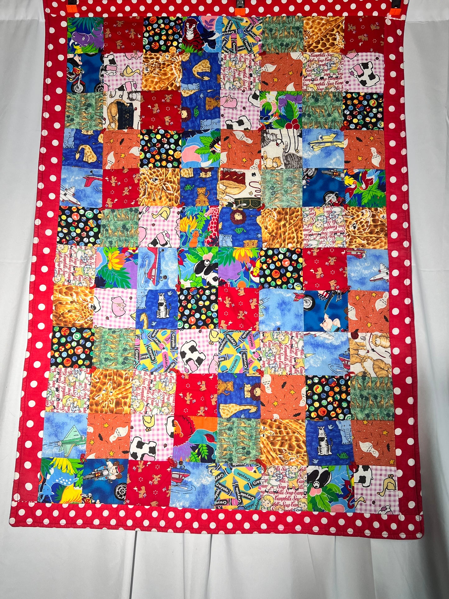 Quilt- fun print squares- 33” x 46” - polkadot trim- kid or baby blanket