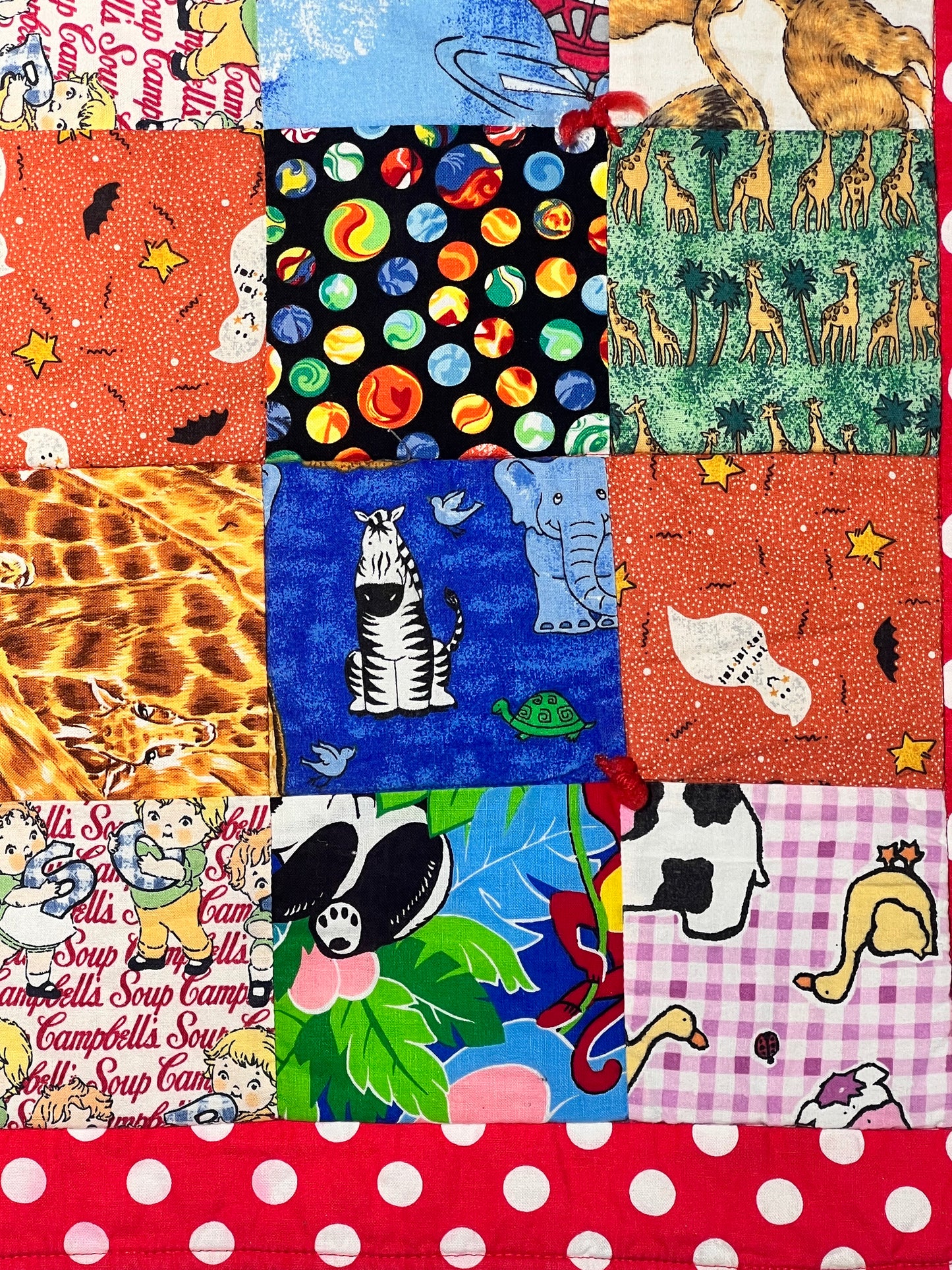 Quilt- fun print squares- 33” x 46” - polkadot trim- kid or baby blanket