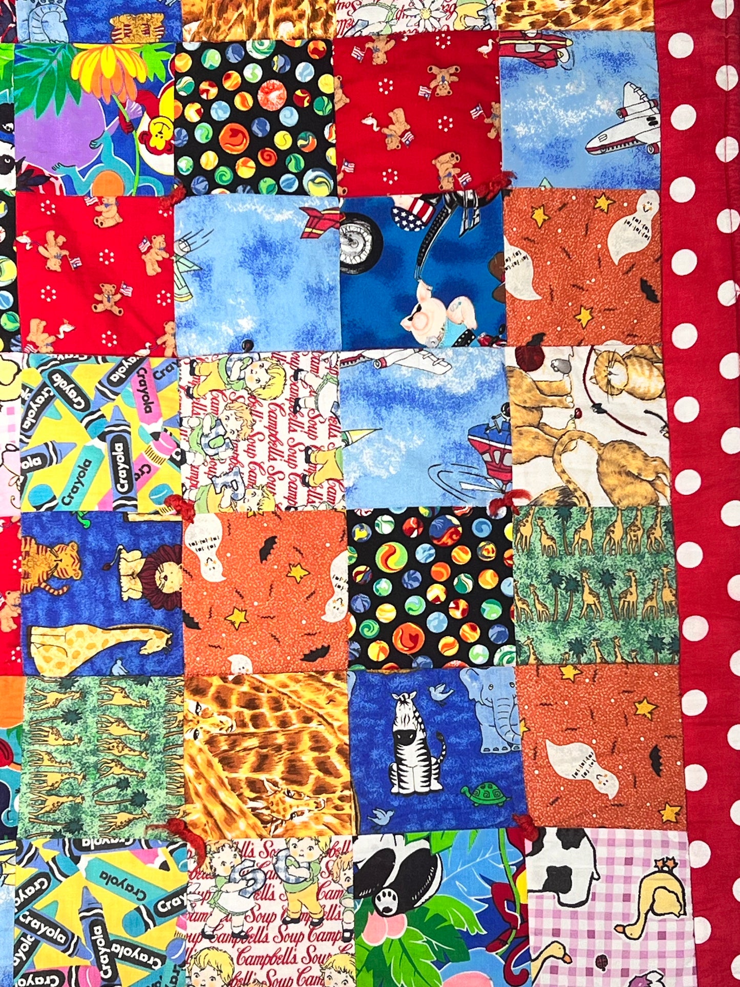 Quilt- fun print squares- 33” x 46” - polkadot trim- kid or baby blanket