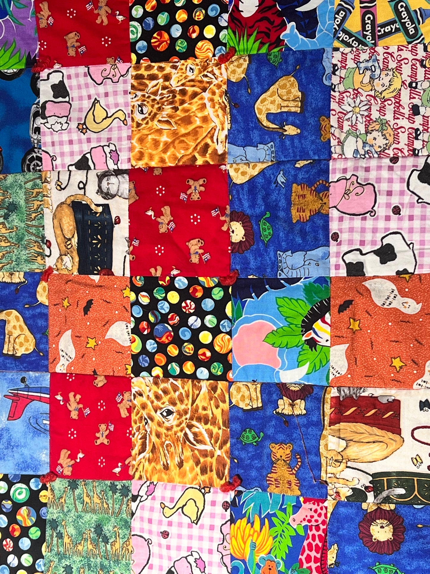 Quilt- fun print squares- 33” x 46” - polkadot trim- kid or baby blanket